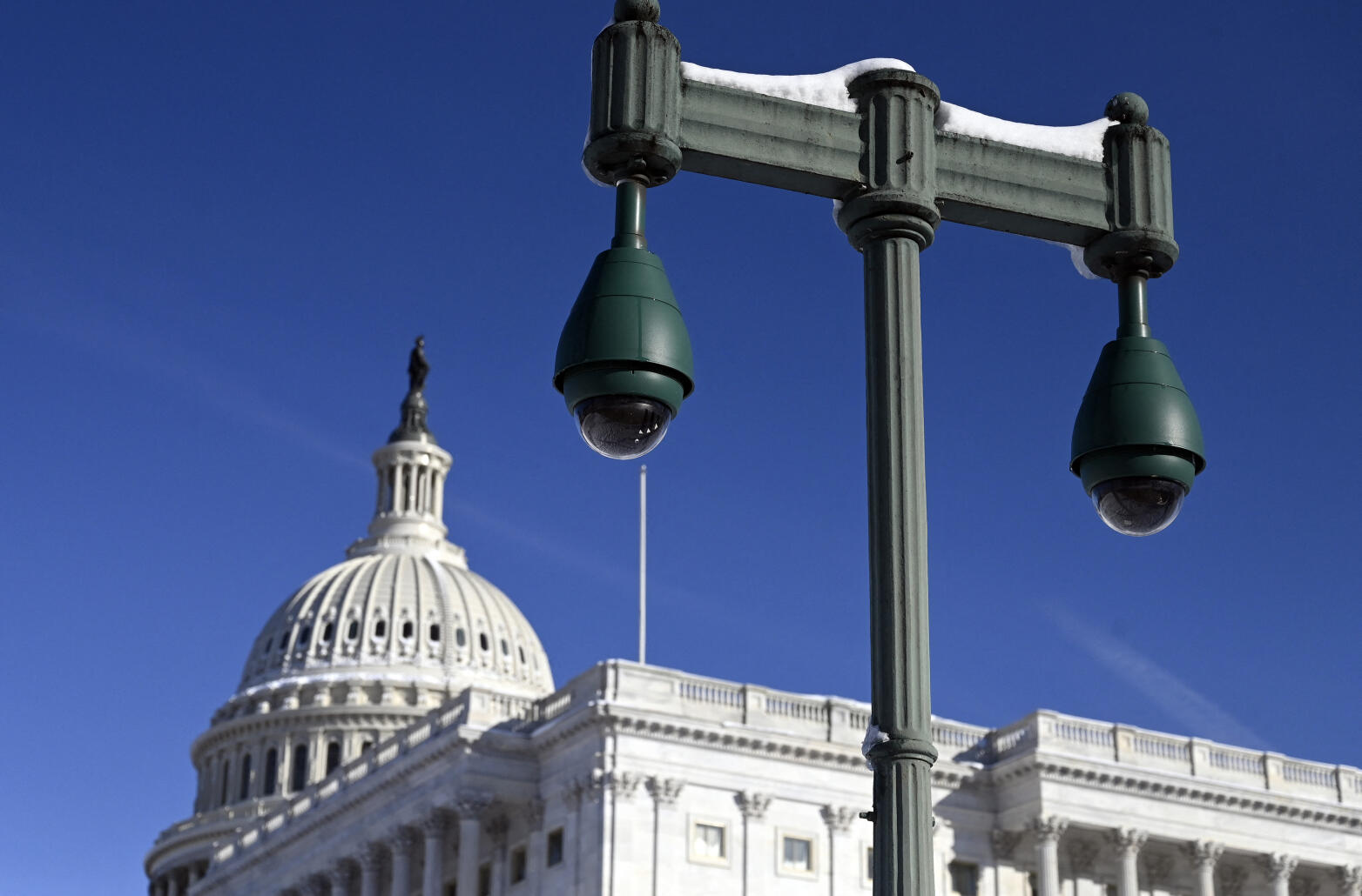 Newly installed surveillance cameras are positioned near the US Capitol Building on January 4, 2022 in Washington, DC. (Photo by OLIVIER DOULIERY / AFP)